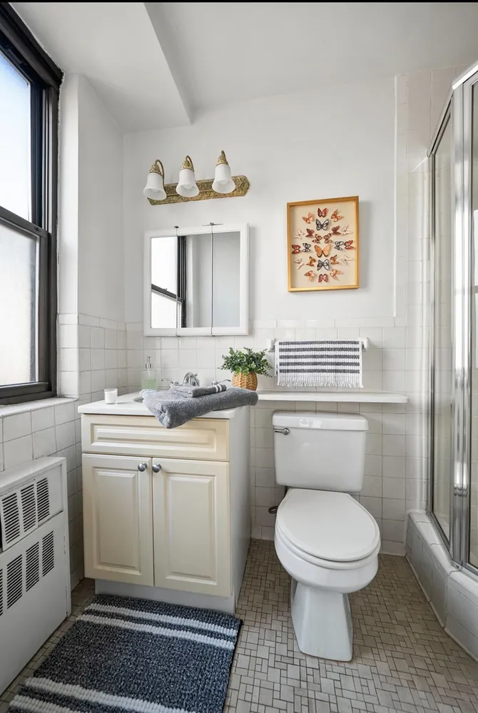 a bathroom with a toilet a sink and mirror