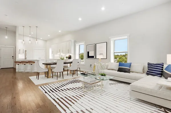 a living room with furniture and a wooden floor
