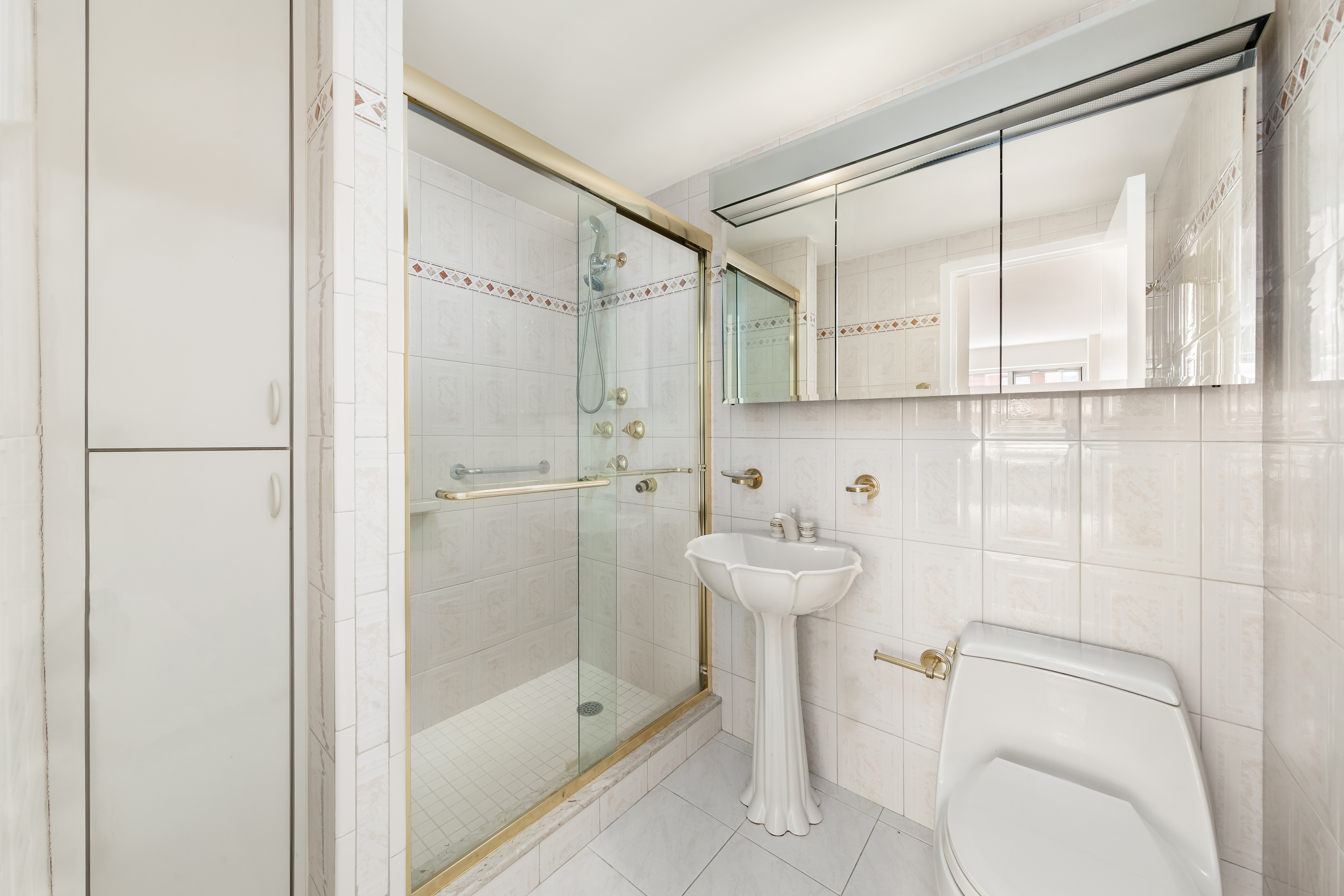 45 Sutton Place South, Unit 14N Manhattan, NY 10022 - Photo 12 of 19 a bathroom with a shower and a toilet