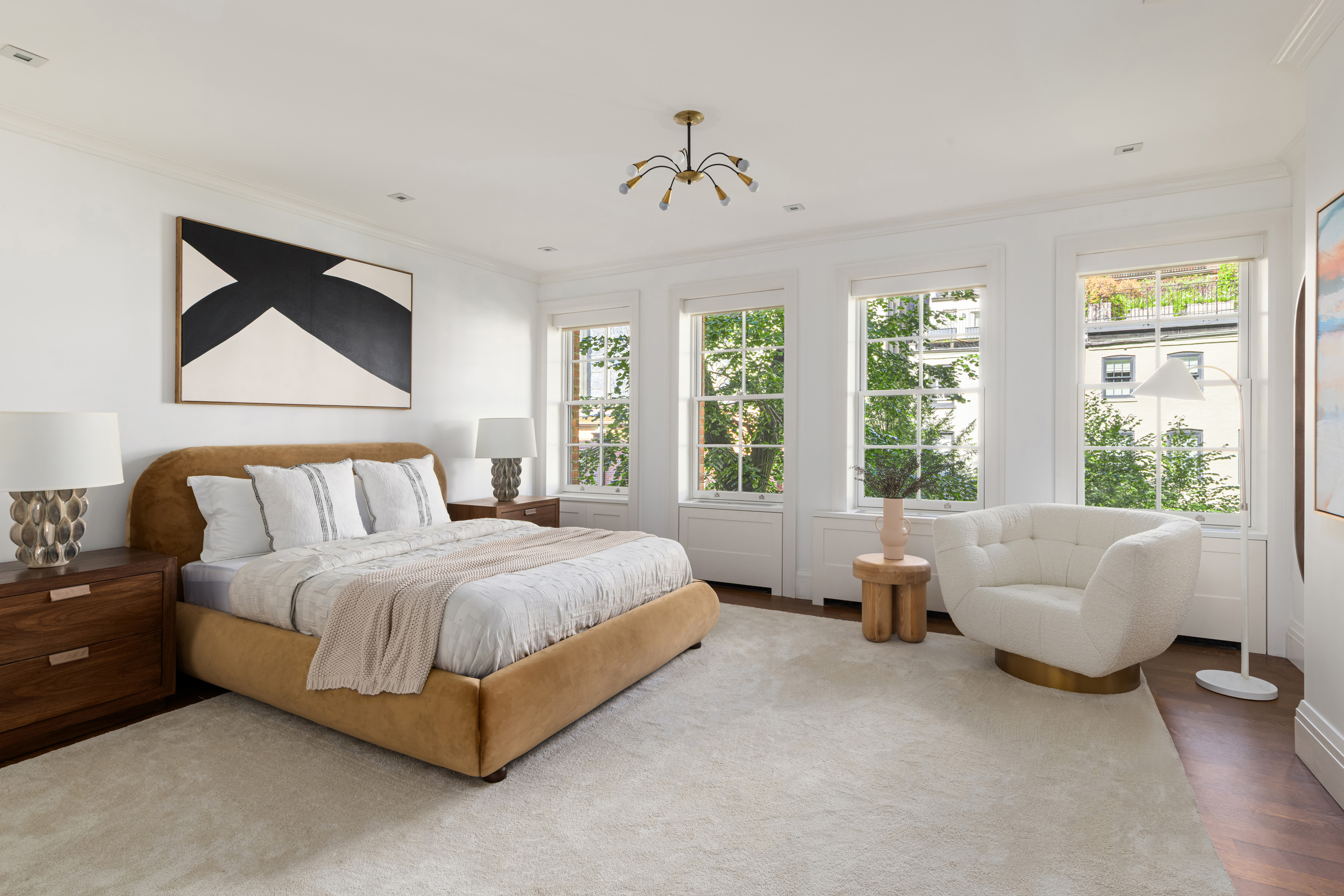 157 East 65th Street Manhattan, NY 10065 - Photo 16 of 28 a spacious bedroom with a bed and a couch