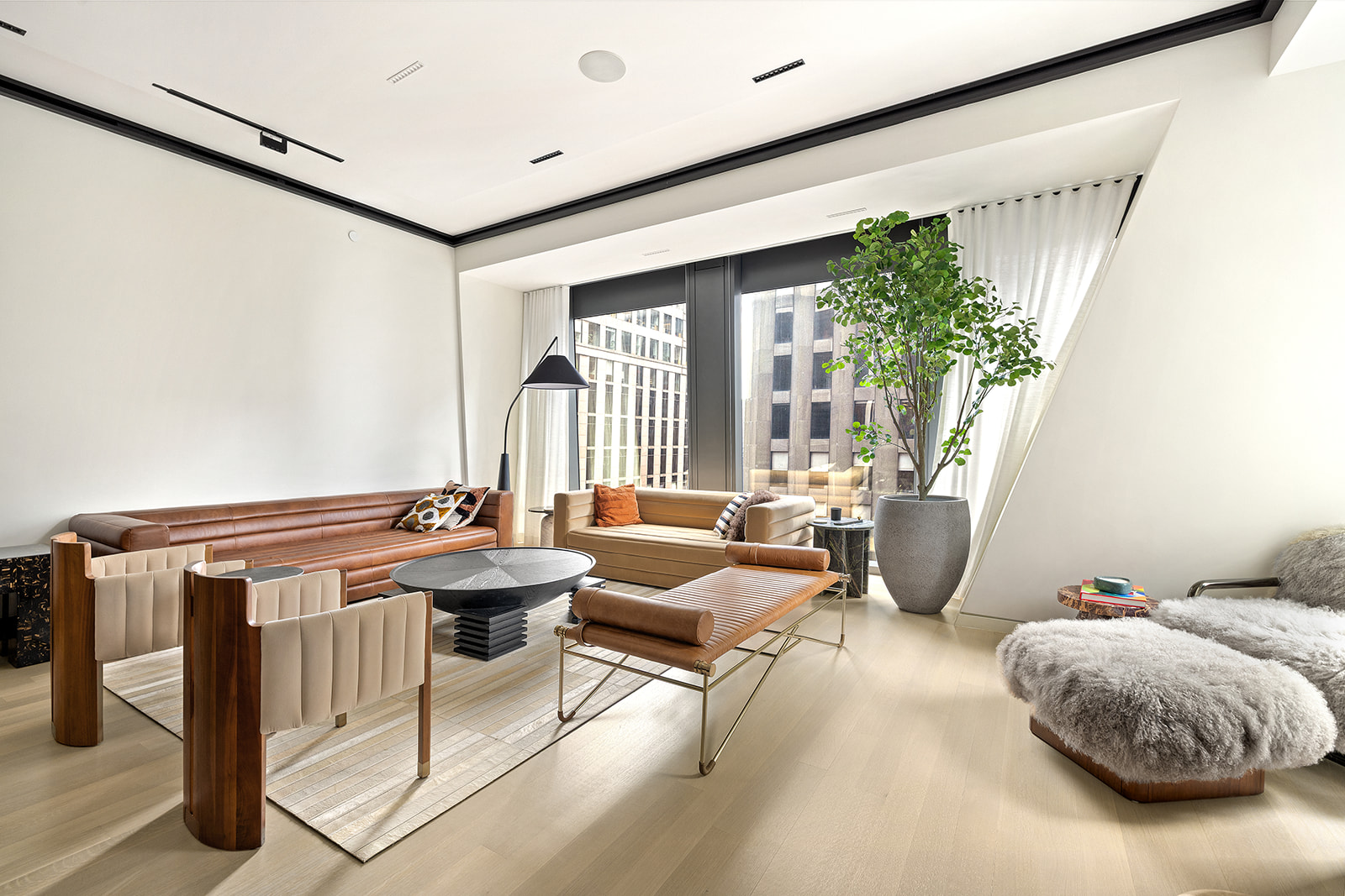 a living room with furniture and a potted plant