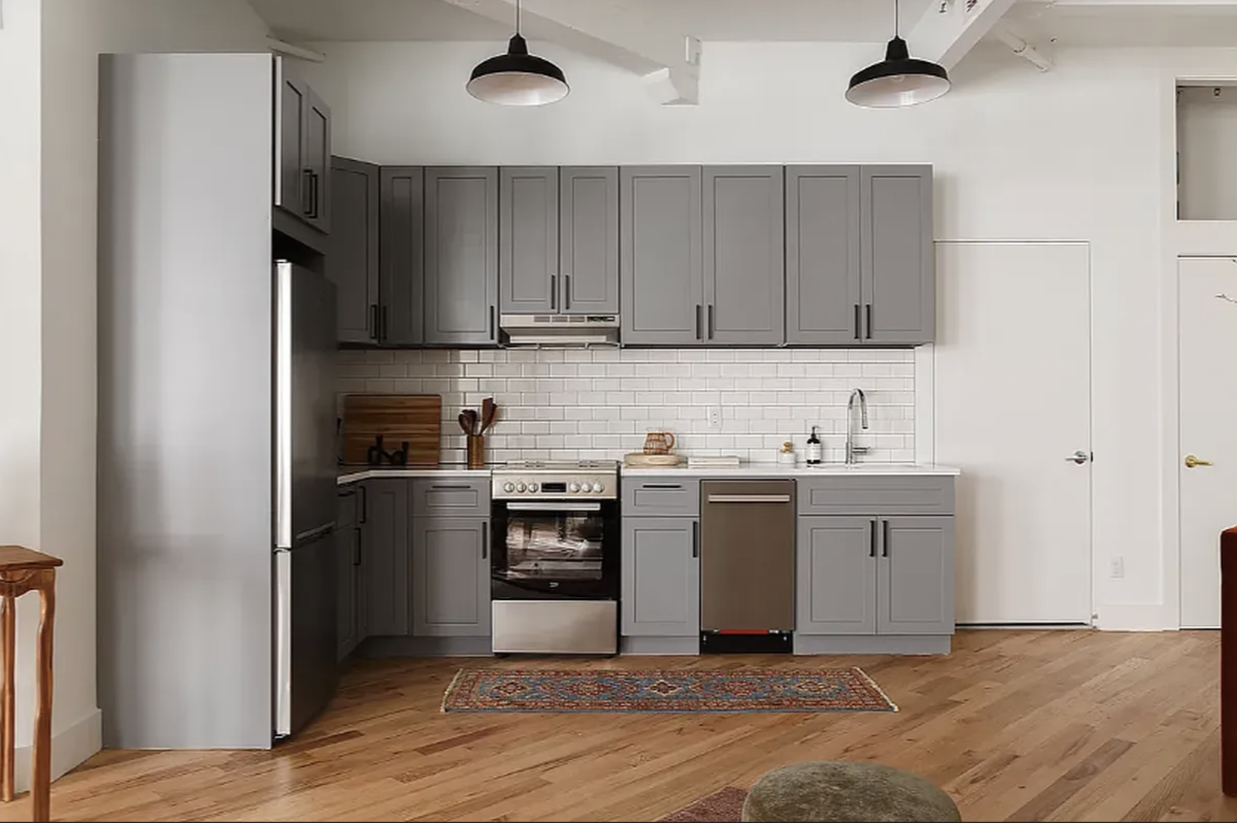 239 Banker Street Brooklyn, NY 11222 - Photo 7 of 11 a kitchen with stainless steel appliances granite countertop a refrigerator and a sink