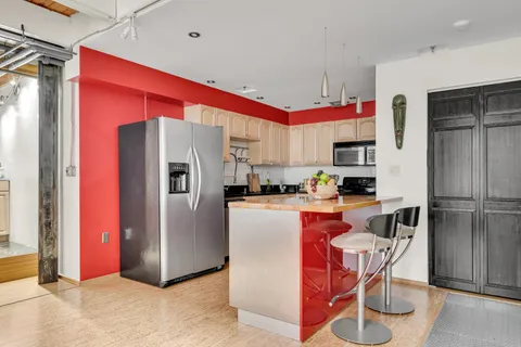 a kitchen with stainless steel appliances granite countertop a sink a stove and cabinets