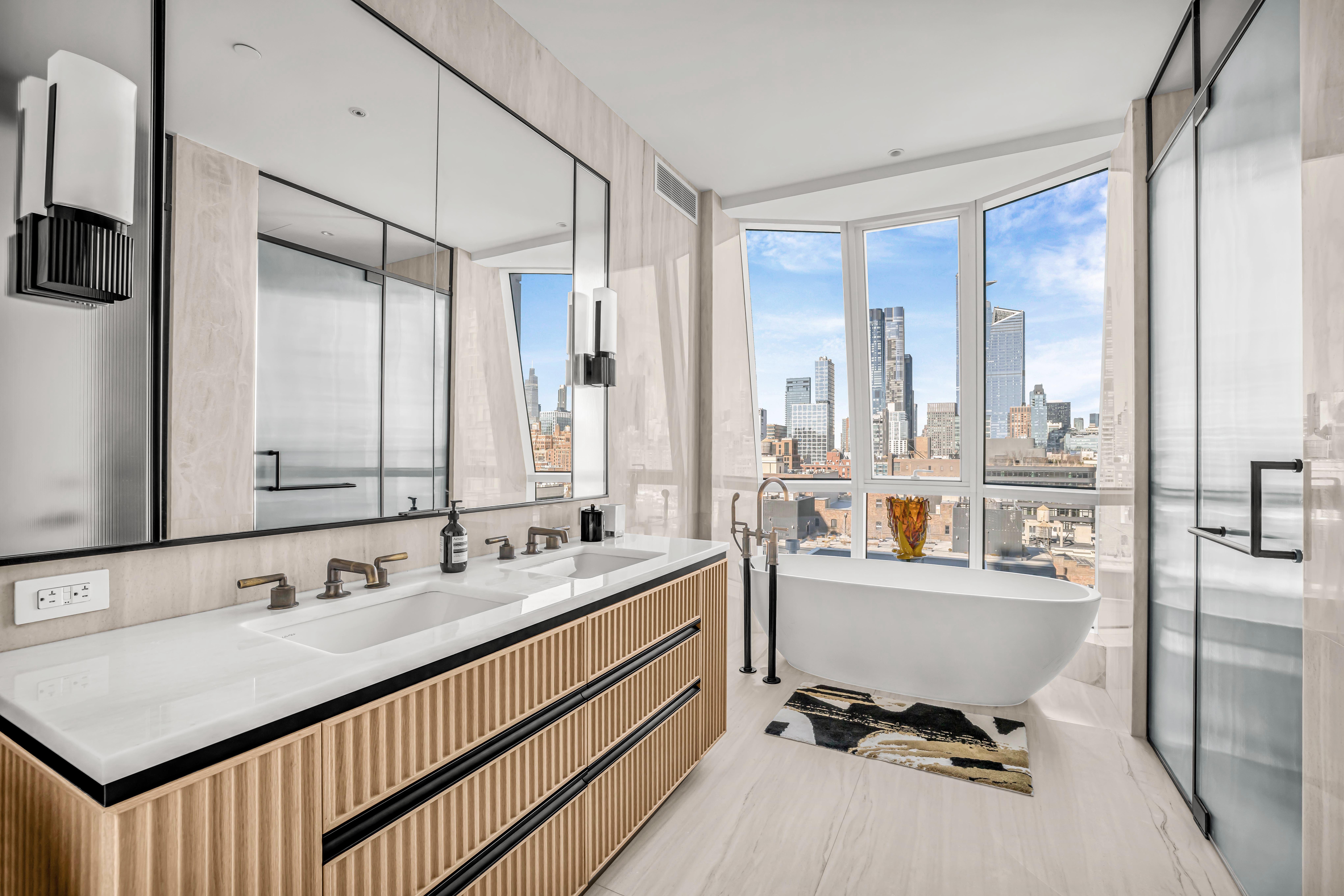 515 West 18th Street, Unit 1504 Manhattan, NY 10011 - Photo 5 of 11 a bathroom with a double vanity sink a mirror and next to a window