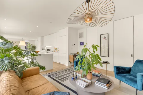a living room with furniture and a chandelier