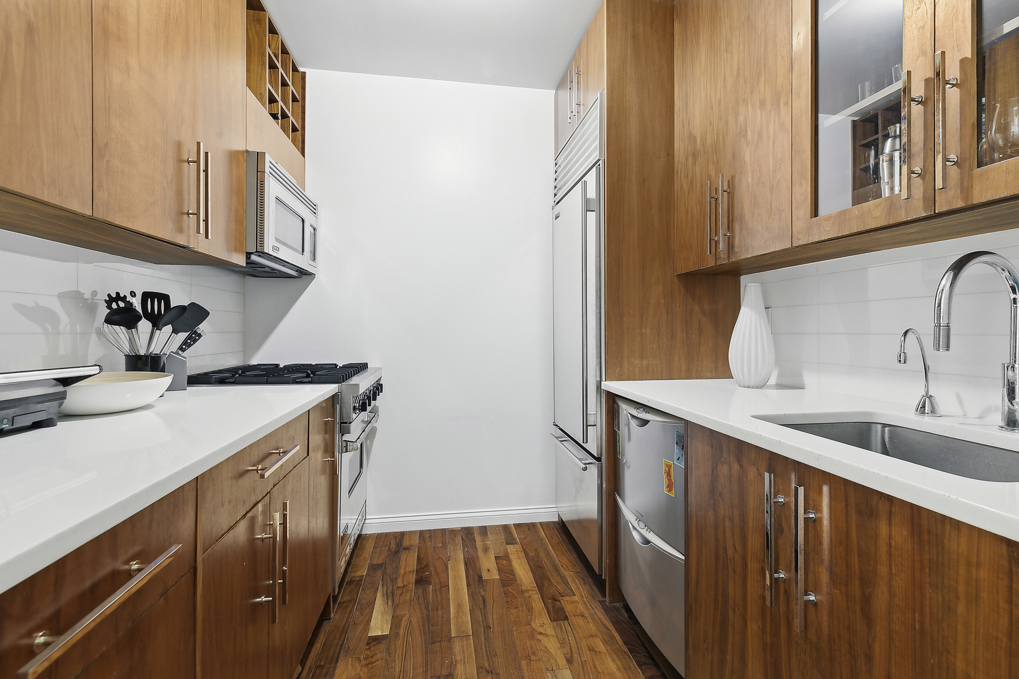 88 Greenwich Street, Unit 3003 Manhattan, NY 10006 - Photo 3 of 19 a kitchen with a sink and cabinets