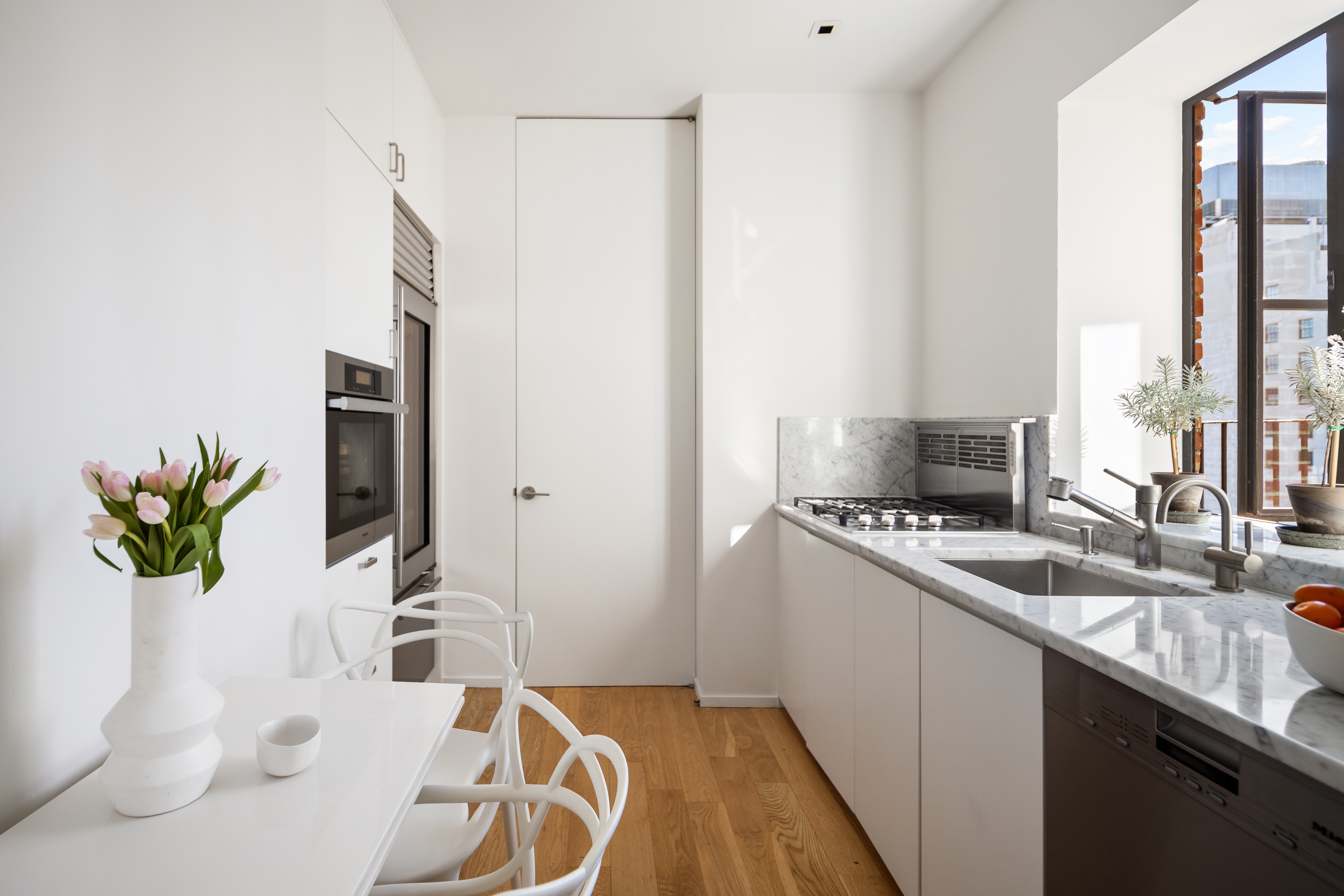 200 East 16th Street, Unit PHC Manhattan, NY 10003 - Photo 3 of 9 a kitchen with a sink a counter top space and cabinets