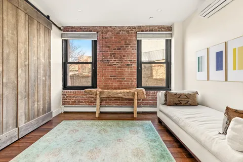 a bedroom with furniture and a window