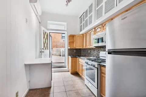 a kitchen with stainless steel appliances granite countertop a refrigerator and a stove