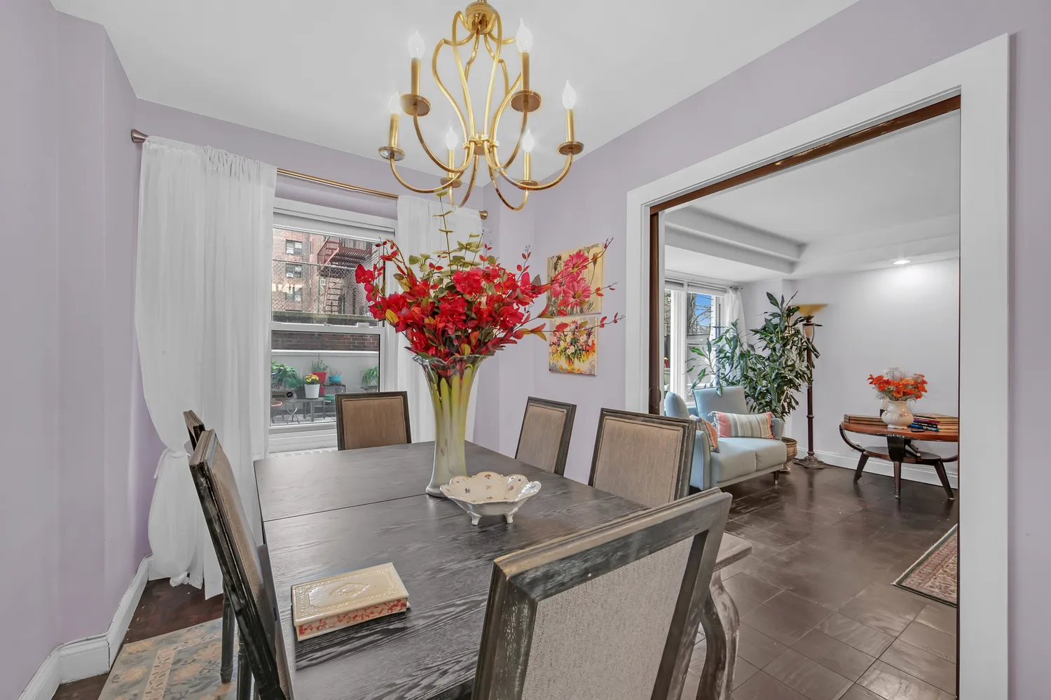 a view of a dining room with furniture a chandelier and wooden floor