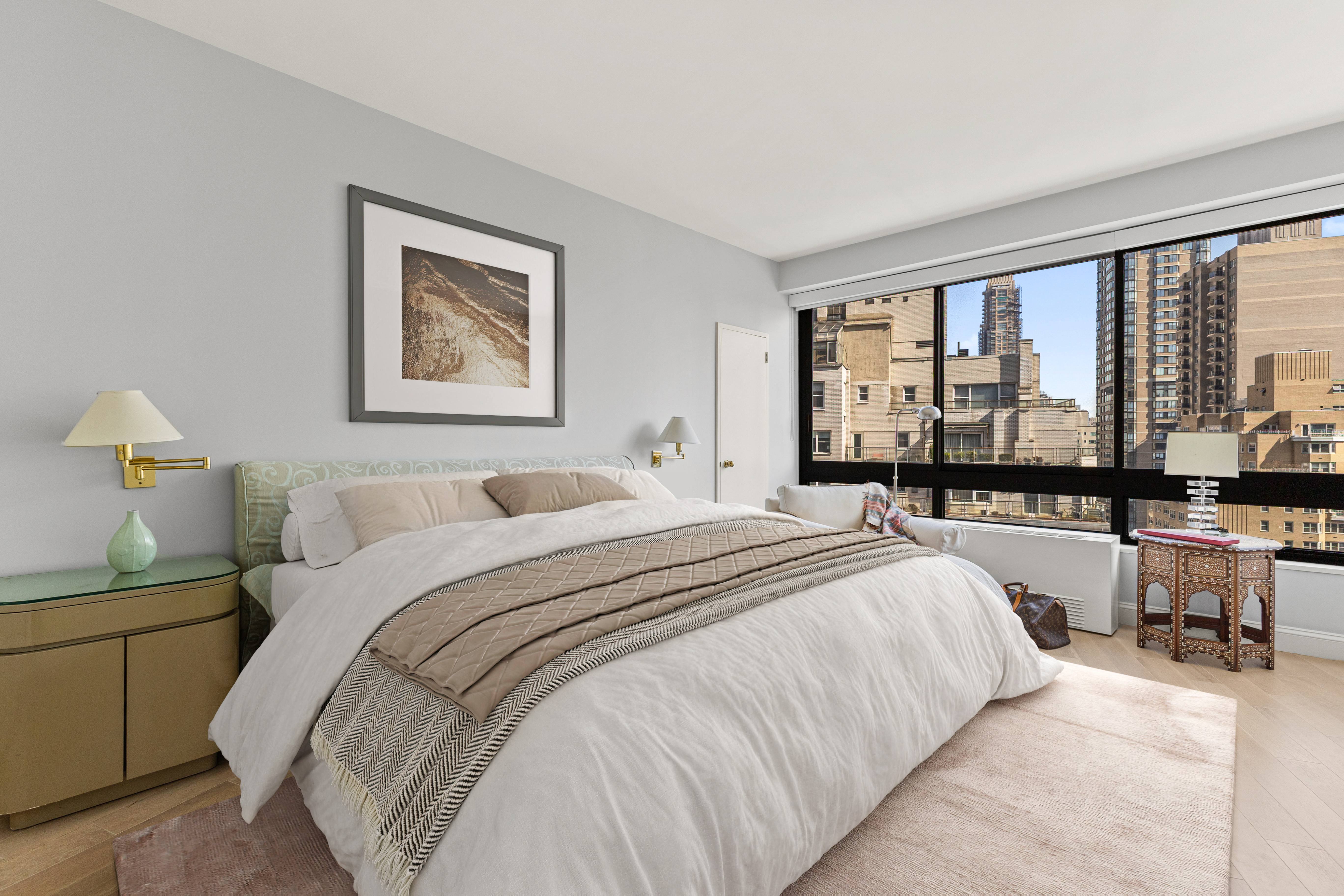 167 East 61st Street, Unit 20E Manhattan, NY 10065 - Photo 10 of 24 a bedroom with a bed and a large window