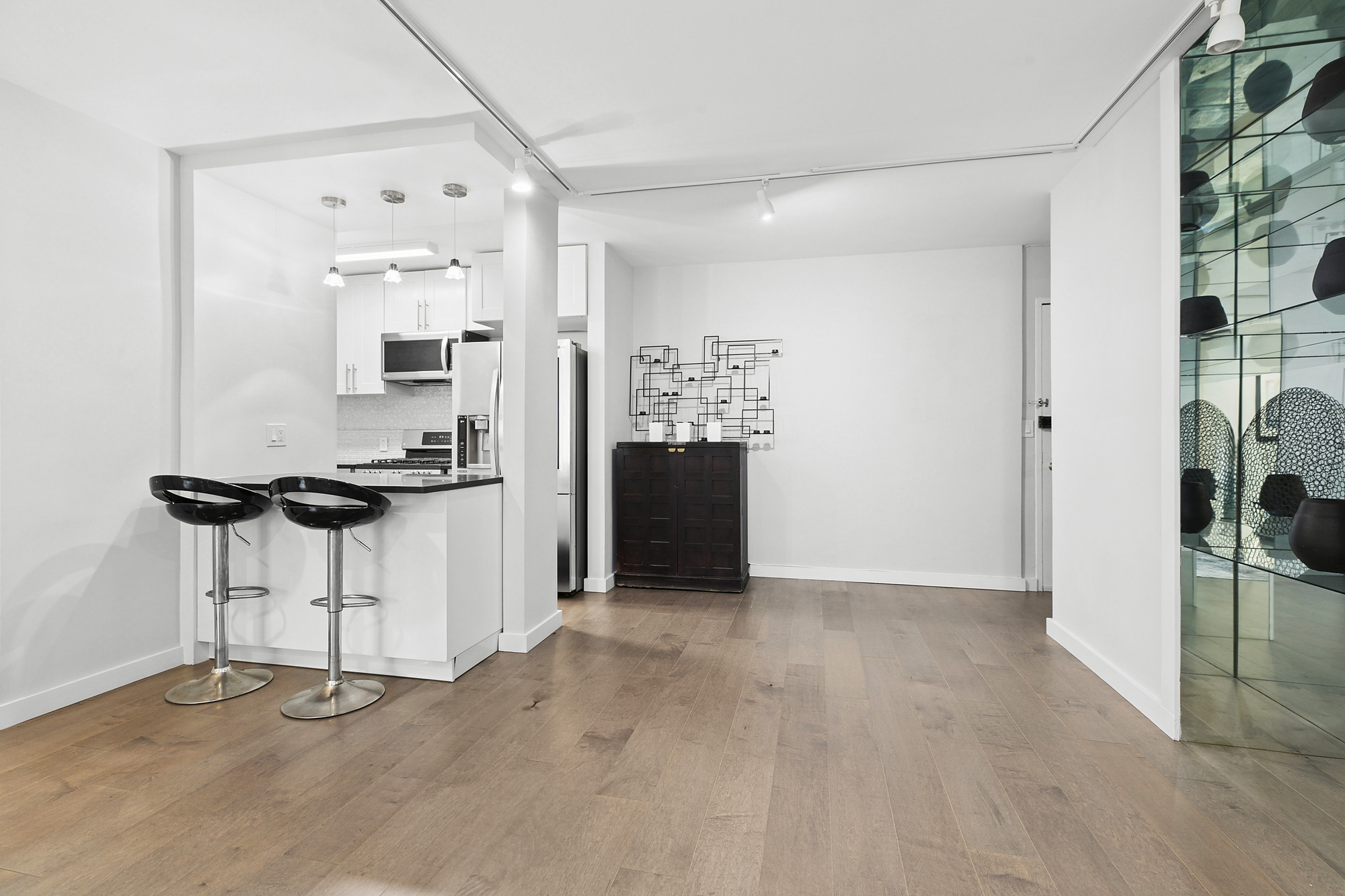 159 West 53rd Street, Unit 11D Manhattan, NY 10019 - Photo 3 of 9 a view of kitchen with refrigerator and window