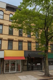 a front view of a building with glass windows and table