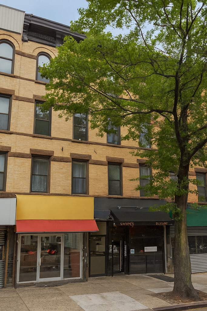 433 Dekalb Avenue Brooklyn, NY 11205 - Photo 8 of 8 a front view of a building with glass windows and table