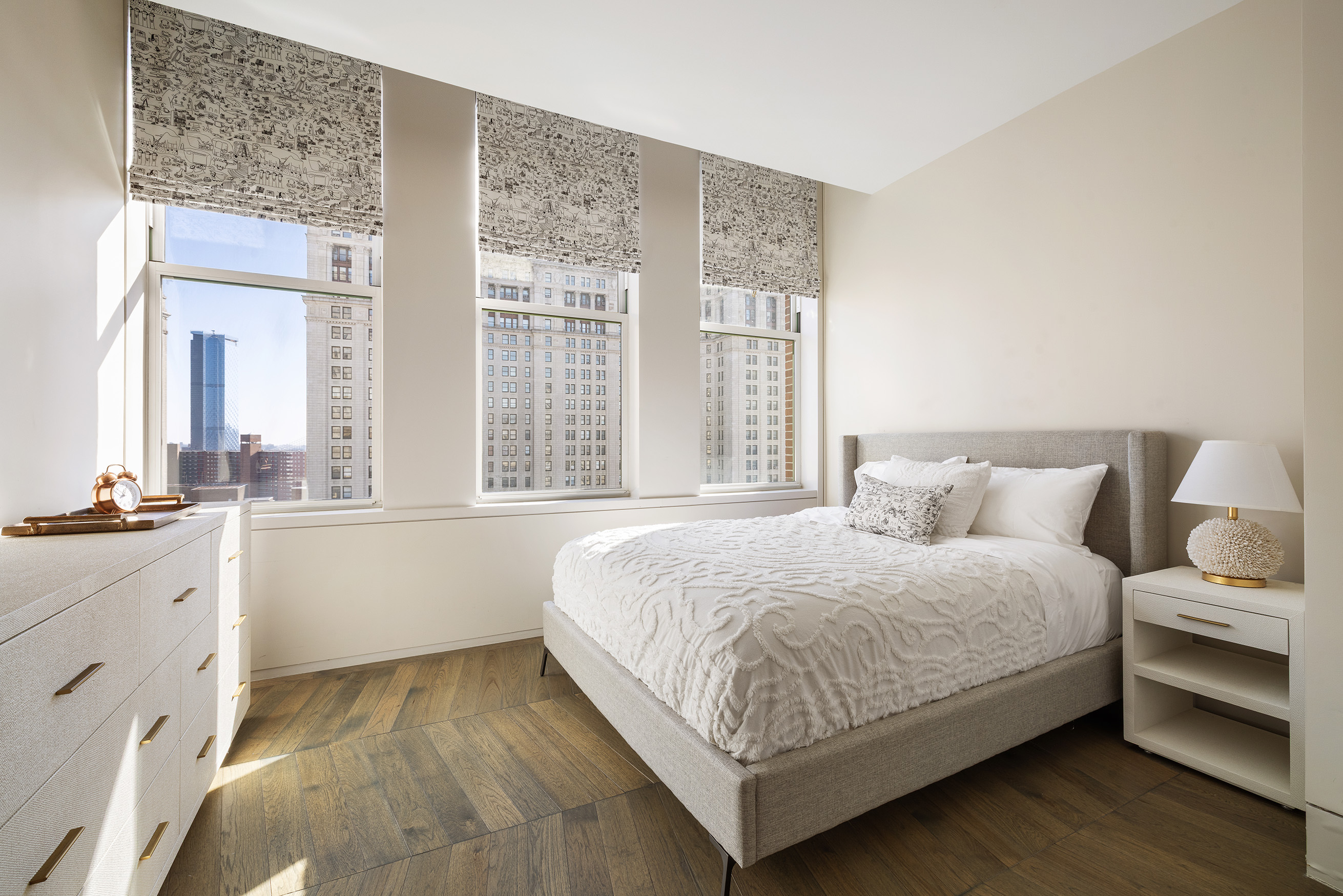 49 Chambers Street, Unit 17H Manhattan, NY 10007 - Photo 9 of 25 a bedroom with a large bed and a large window
