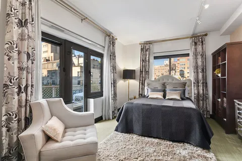 a bedroom with a large bed and a large window