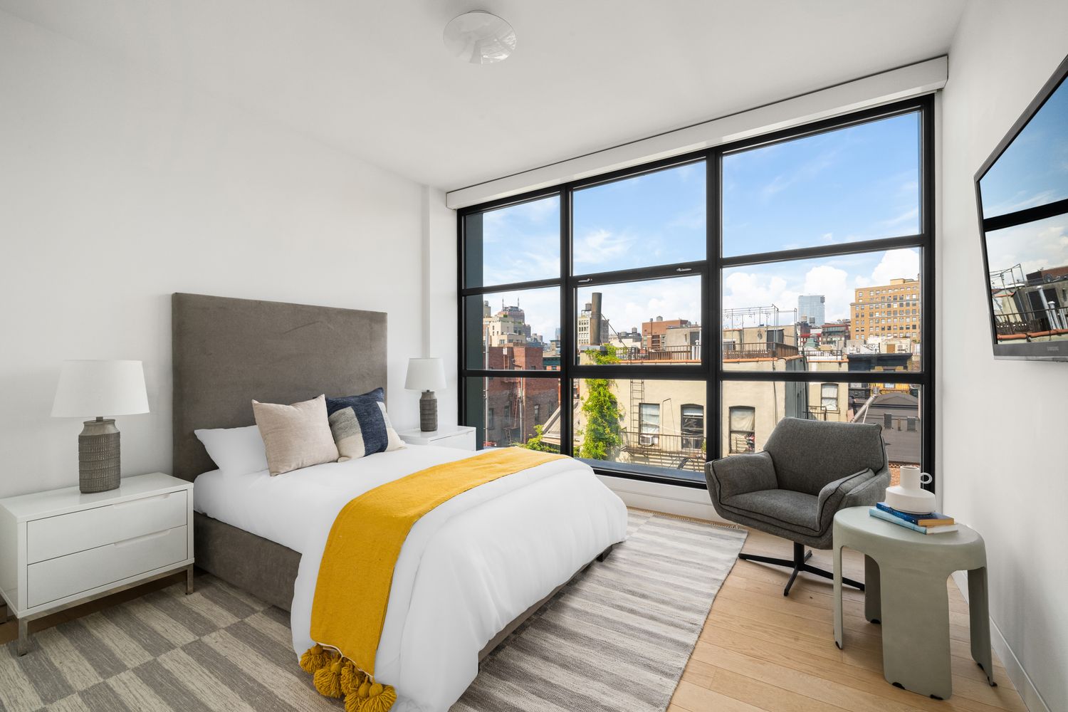 a spacious bedroom with a bed and a large window