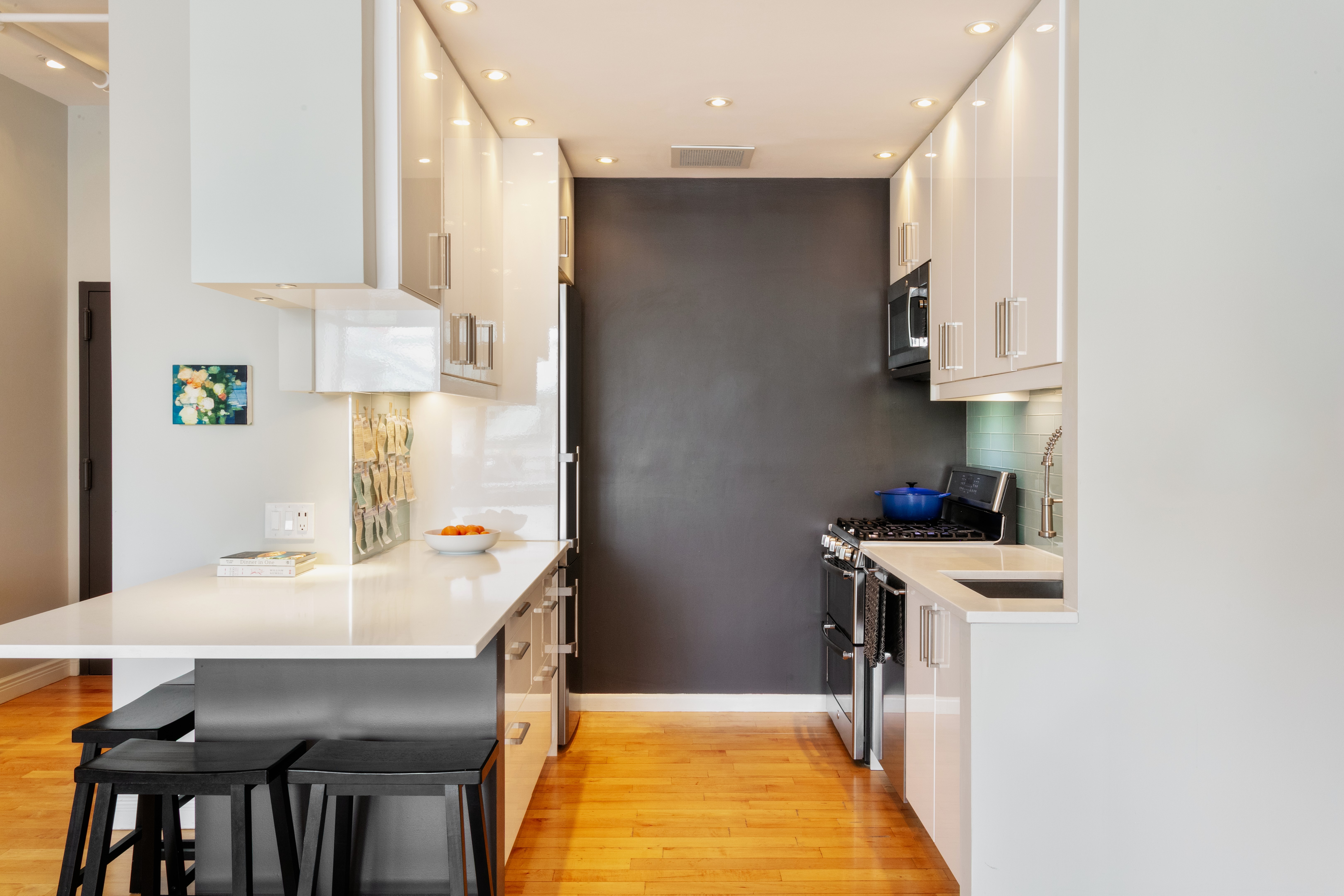 60 Tiffany Place, Unit 3C Brooklyn, NY 11231 - Photo 4 of 10 a kitchen with kitchen island a stove a table and chairs in it