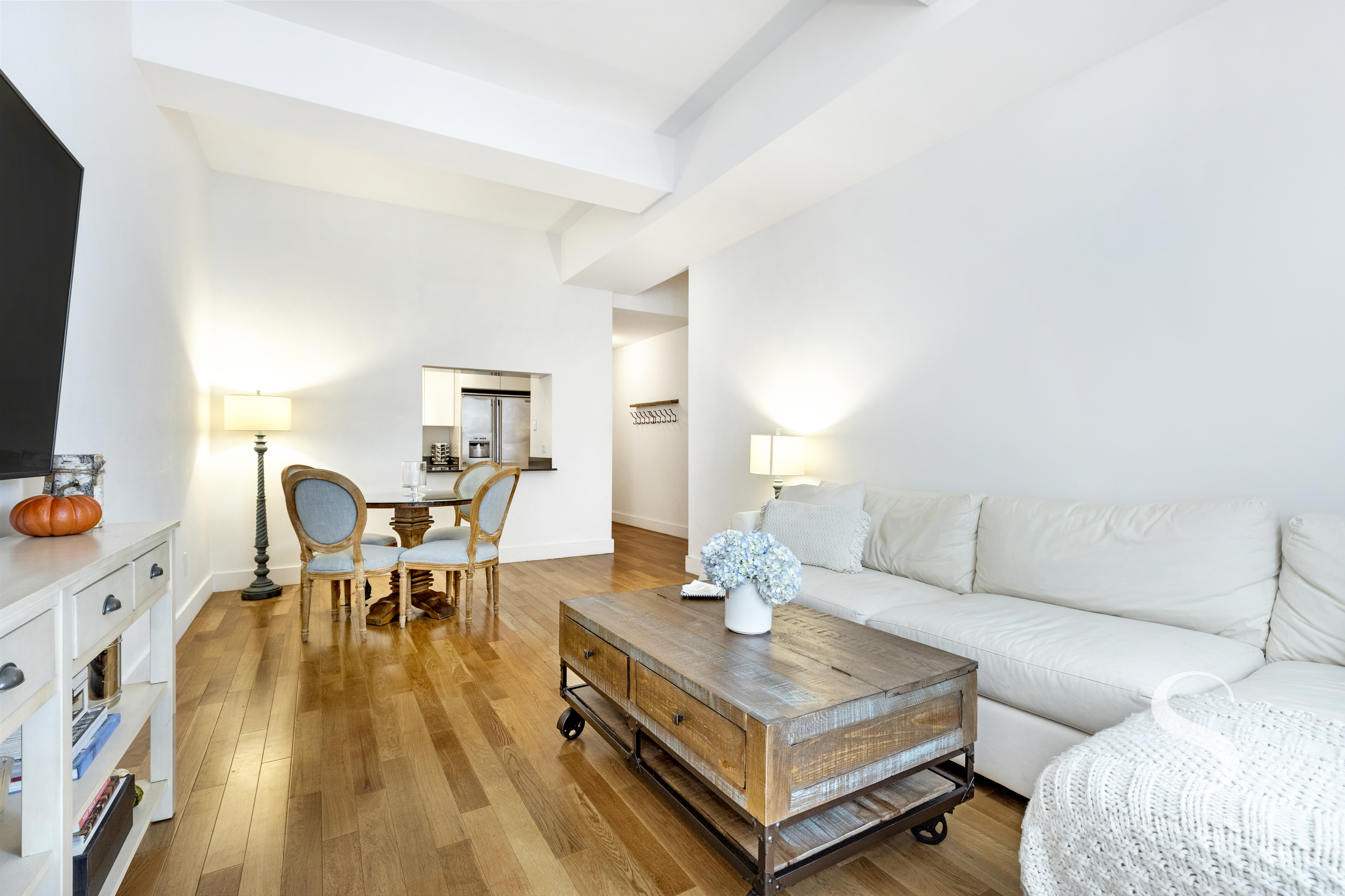 99 John Street, Unit 910 Manhattan, NY 10038 - Photo 2 of 11 a living room with furniture and a table
