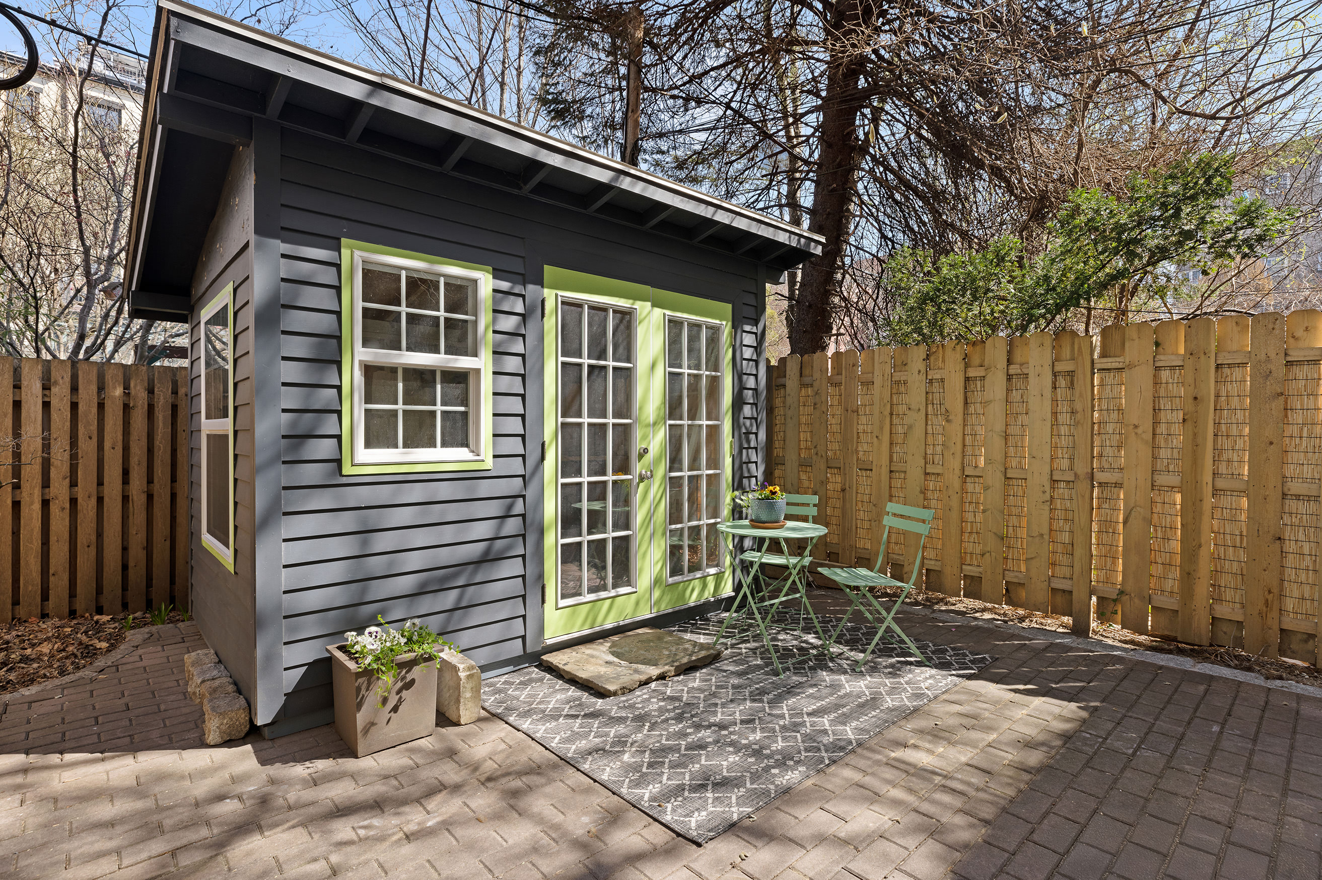 193 Sterling Place, Unit 2 Brooklyn, NY 11238 - Photo 6 of 15 a backyard of a house with chairs and wooden fence