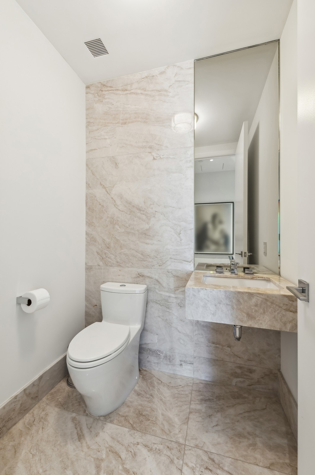 15 Hudson Yards, Unit 74F Manhattan, NY 10001 - Photo 10 of 13 a bathroom with a granite countertop toilet a sink and mirror