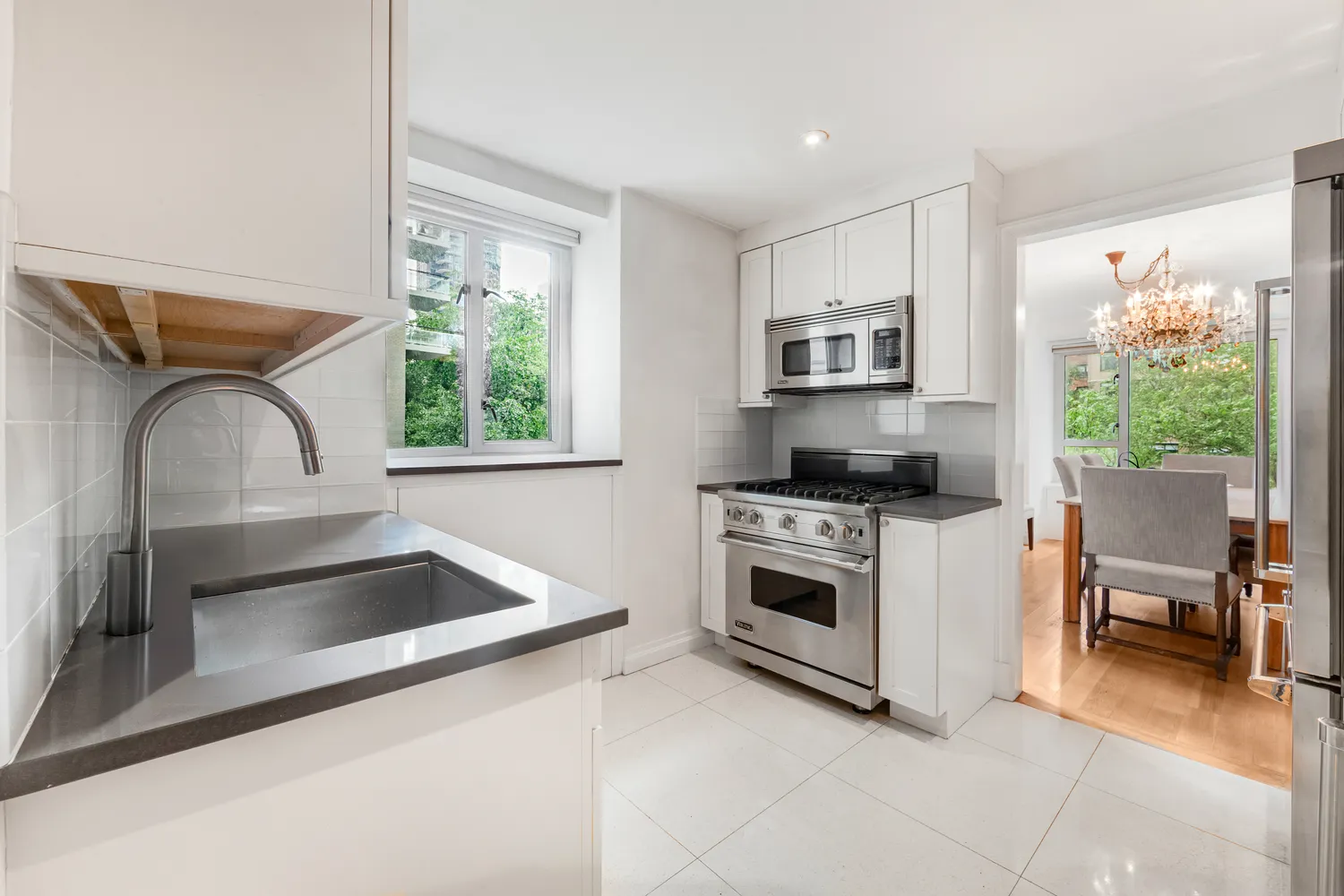 a kitchen that has a sink and a stove top oven