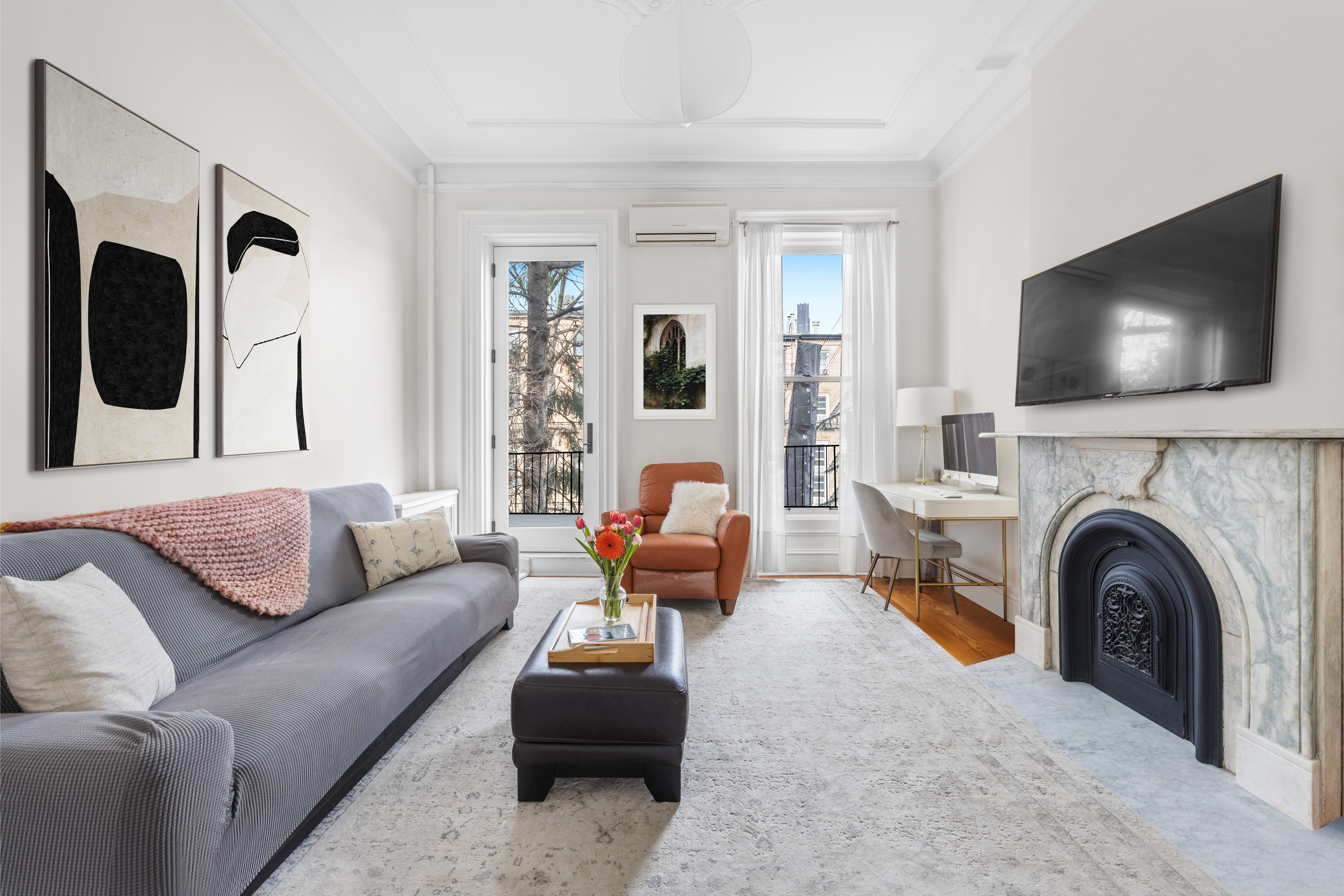 387 Union Street, Unit 2 Brooklyn, NY 11231 - Photo 1 of 12 a living room with furniture and a flat screen tv