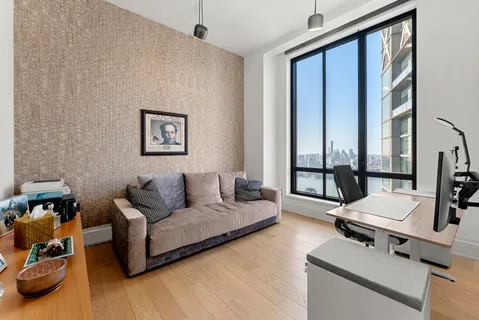 a living room with furniture and large windows