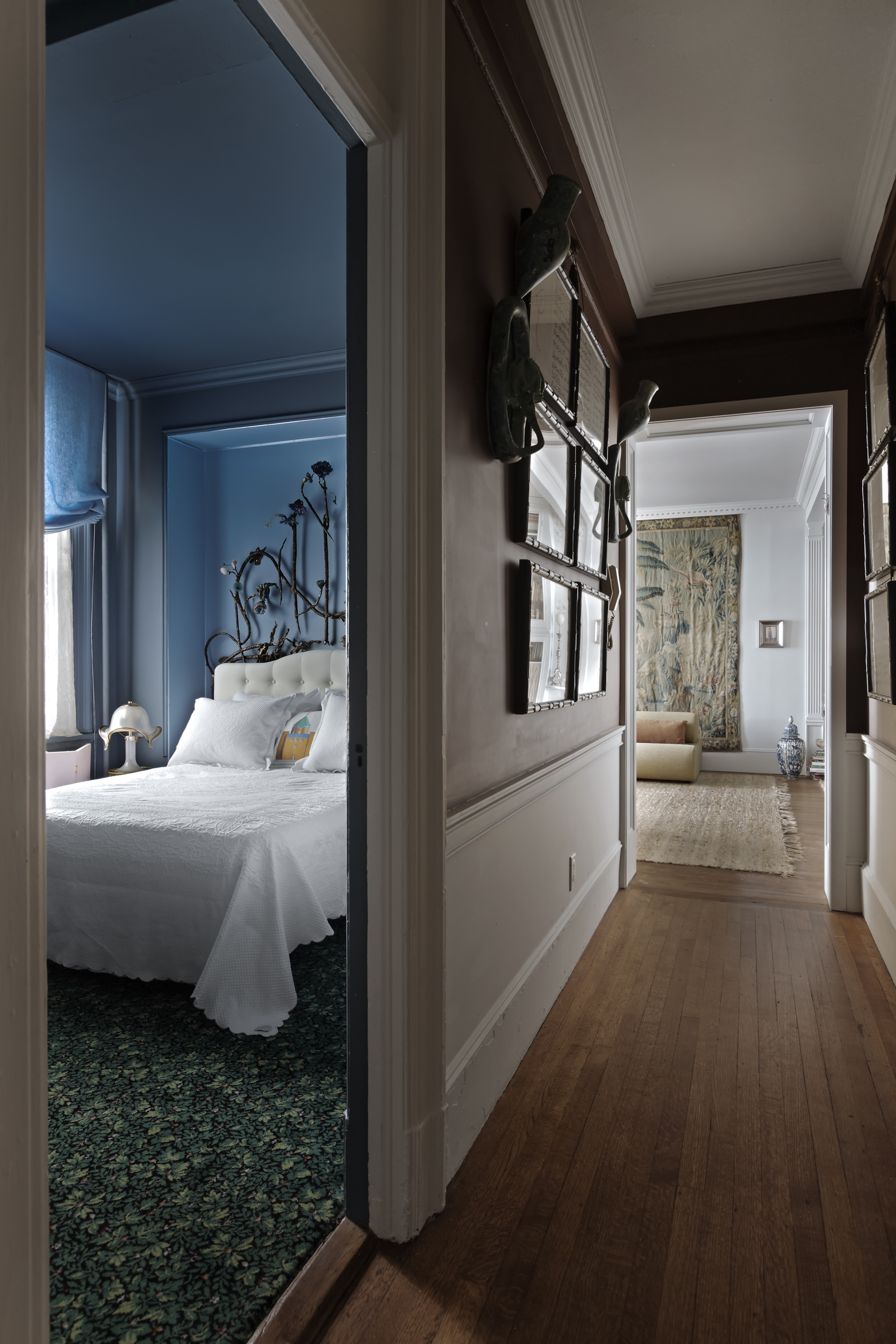 212 East 48th Street, Unit 8E Manhattan, NY 10017 - Photo 7 of 14 a bed room with a bed and a refrigerator