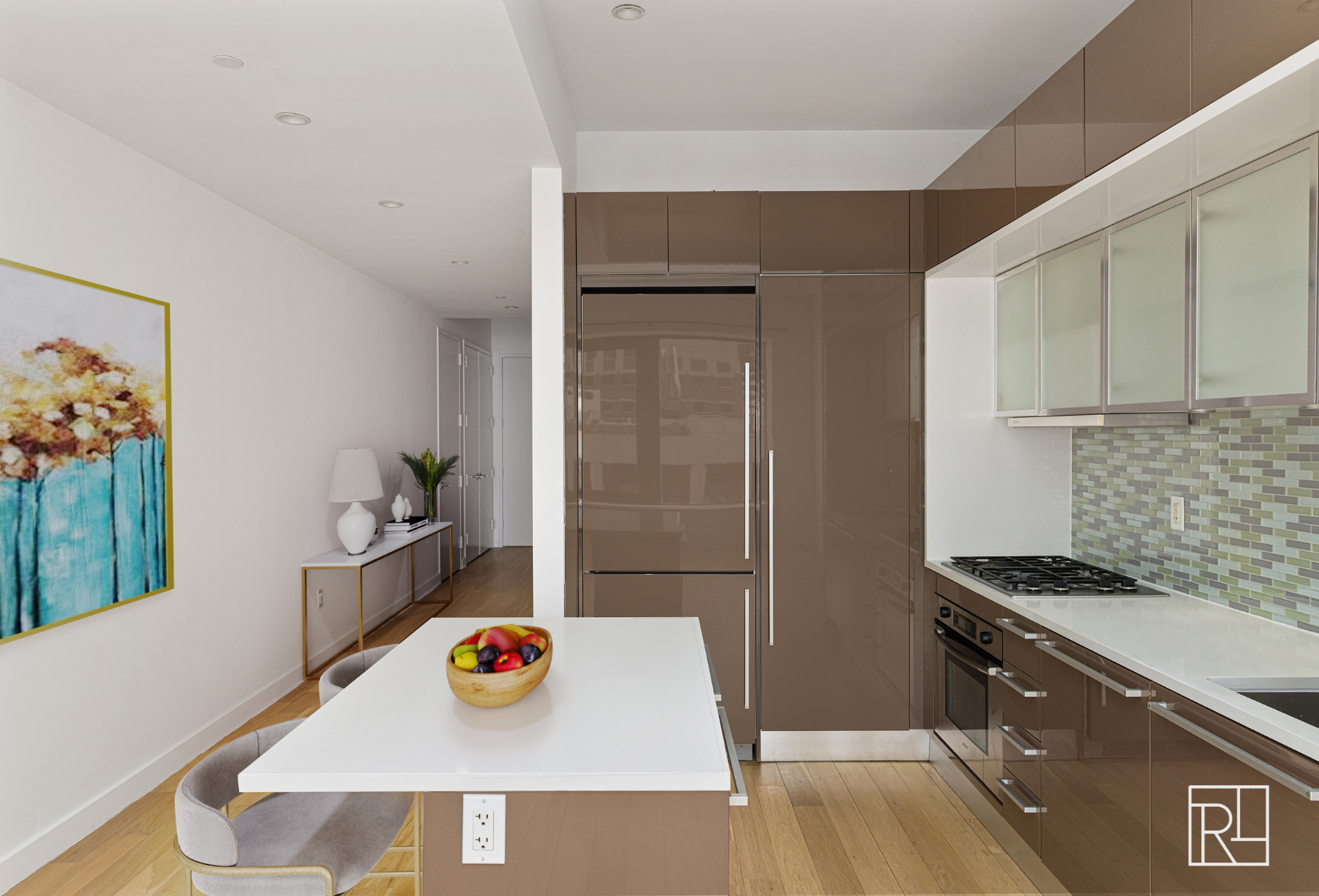 75 Wall Street, Unit 28D Manhattan, NY 10005 - Photo 8 of 35 a kitchen with stainless steel appliances granite countertop a refrigerator and a stove