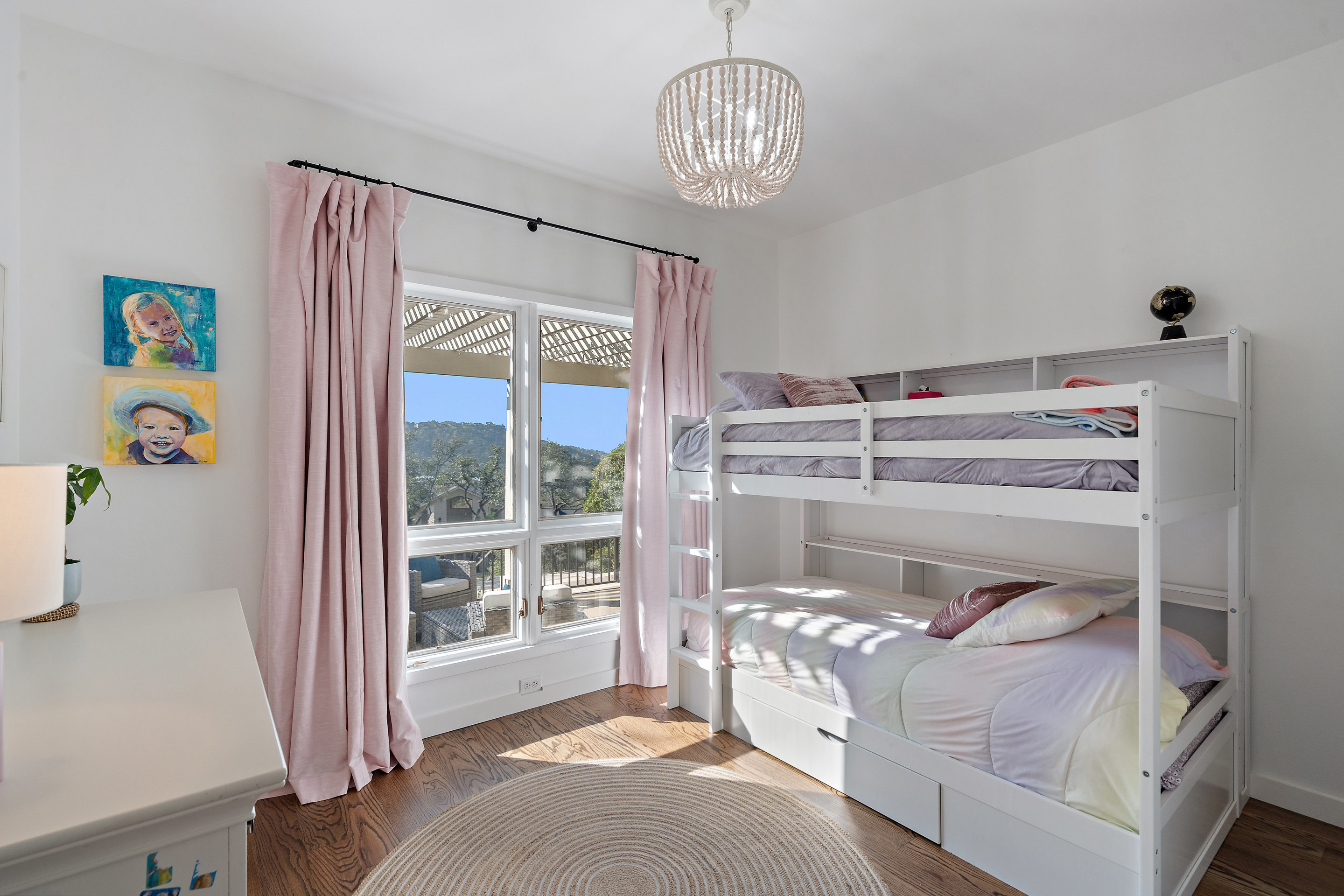 5319 Backtrail Drive Austin, TX 78731 - Photo 29 of 35 a bedroom with a bed and a chandelier