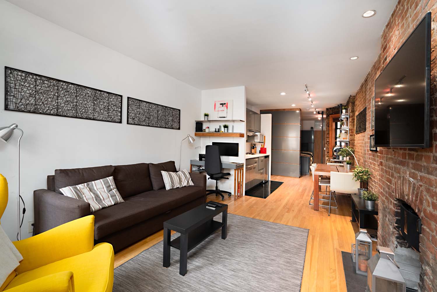 218 East 82nd Street, Unit 4FW Manhattan, NY 10028 - Photo 4 of 9 a living room with furniture and kitchen view