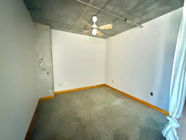 a living room with patio furniture and a table