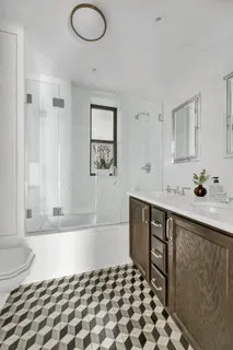 a bathroom with a bathtub sink and mirror