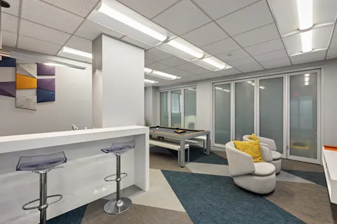 a hallway with furniture and wooden floor