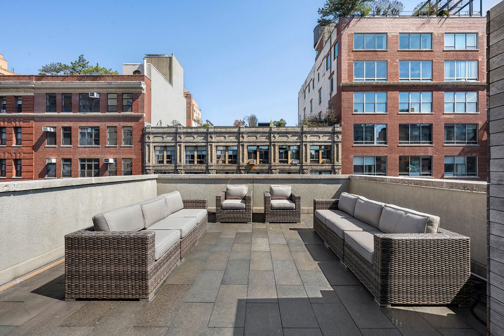 a view of a hallway with wooden floor stairs and windows