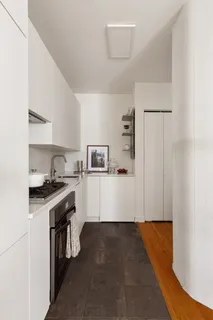 a kitchen with cabinets and a stove