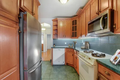 a kitchen with stainless steel appliances granite countertop a stove a refrigerator and a microwave