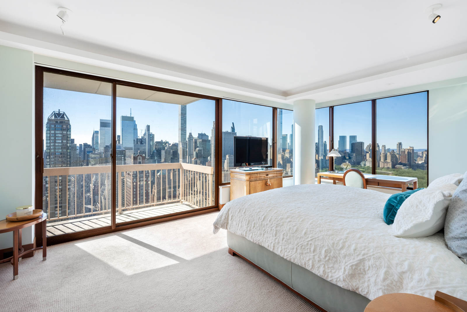 200 East 69th Street, Unit 44A Manhattan, NY 10021 - Photo 8 of 14 a spacious bedroom with a large bed and a large window