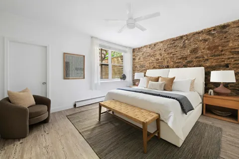 a bedroom with furniture and wooden floor