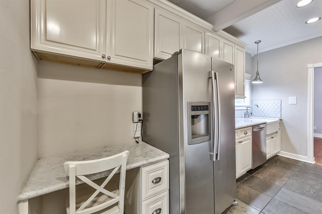 1120 Winston Street Houston, TX 77009 - Photo 18 of 29 a kitchen with stainless steel appliances a refrigerator and cabinets