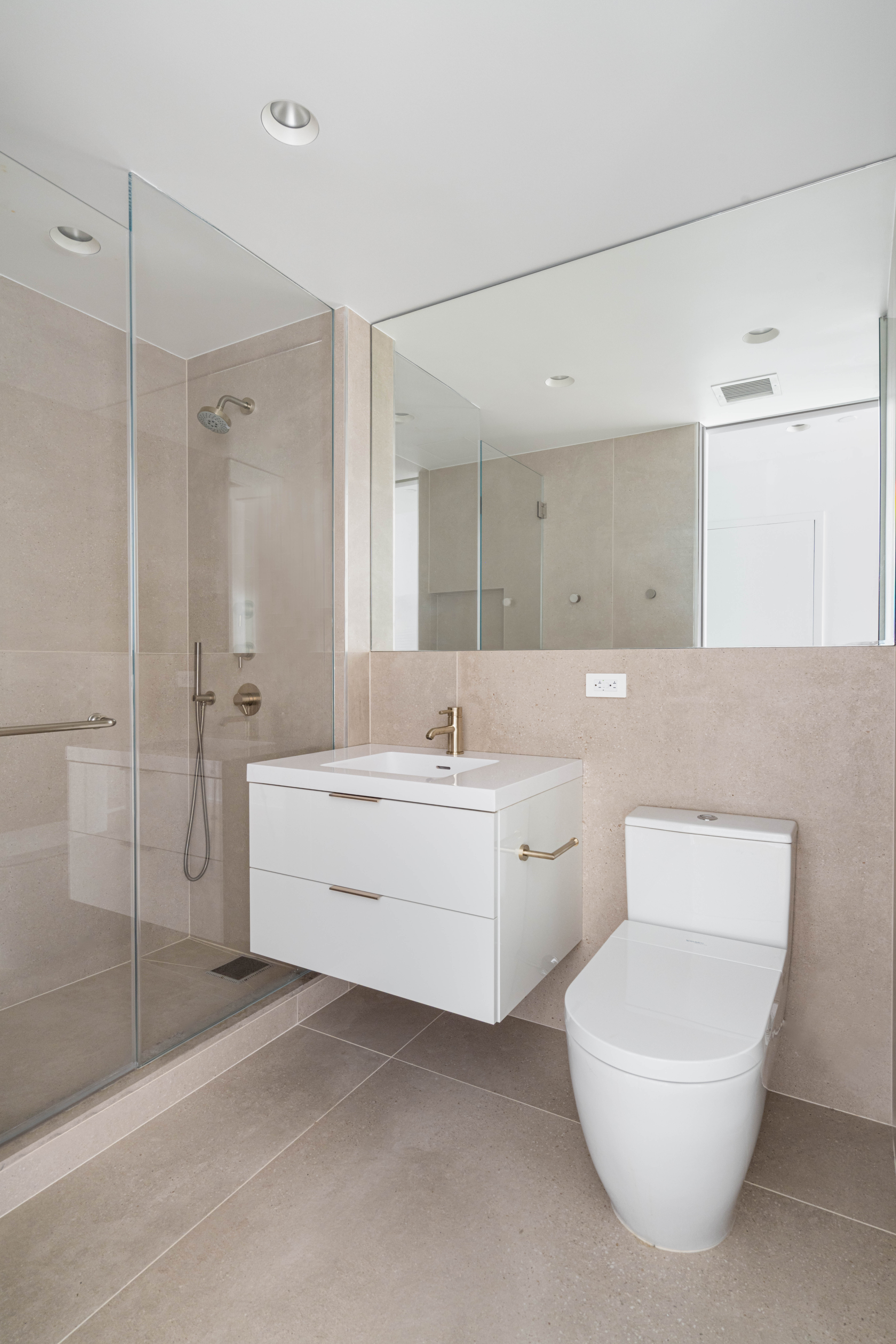 125 West 22nd Street, Unit 10A Manhattan, NY 10011 - Photo 10 of 11 a bathroom with a toilet a sink a mirror and bathtub