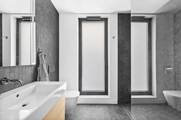 a bathroom with a tub shower and sink
