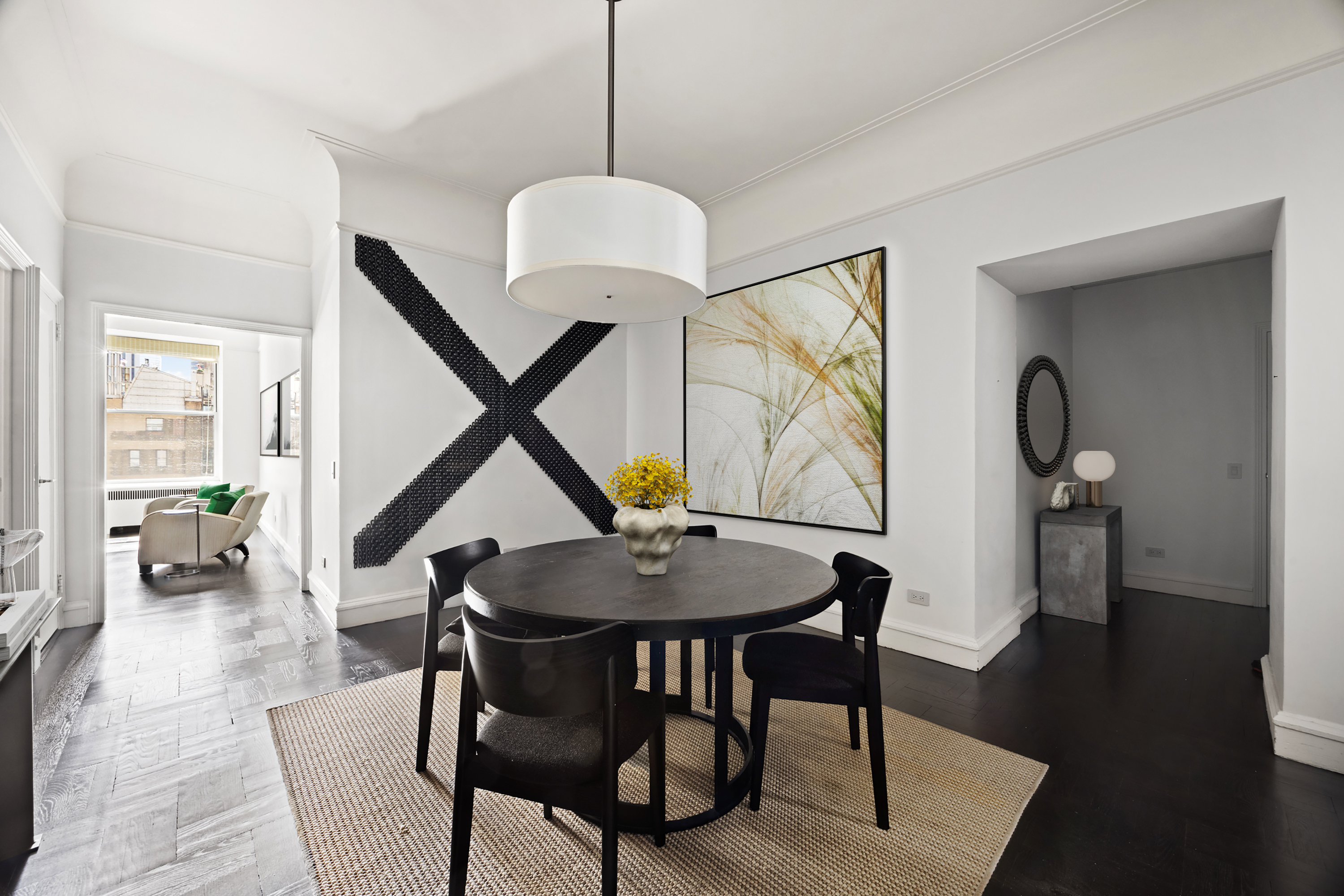 180 West 58th Street, Unit 11A Manhattan, NY 10019 - Photo 5 of 17 a dining room with furniture a chandelier and wooden floor