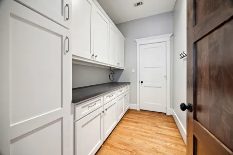 a kitchen with white cabinets and white appliances