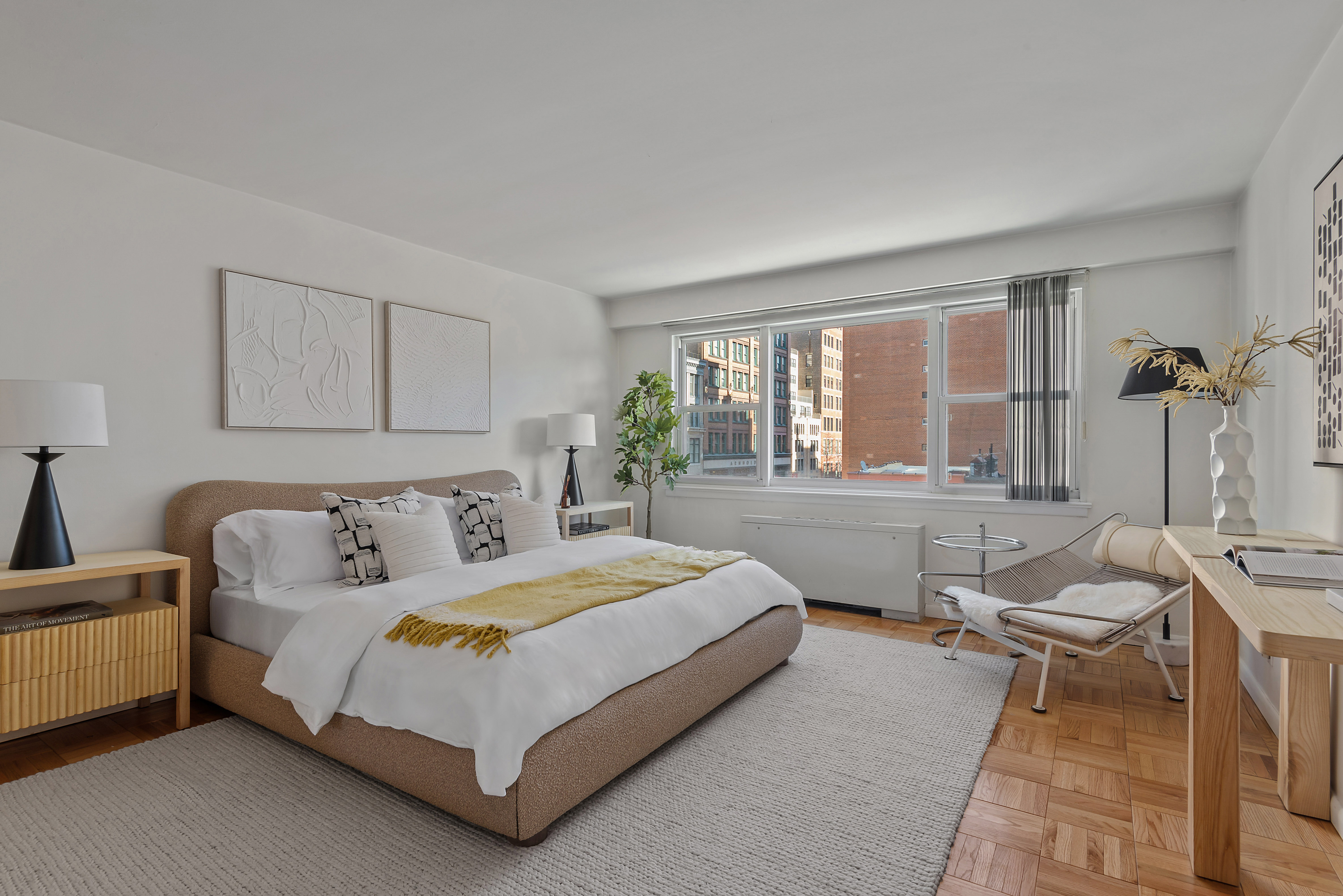 101 West 12th Street, Unit 6MN Manhattan, NY 10011 - Photo 4 of 17 a bedroom with a bed lamp and a large window