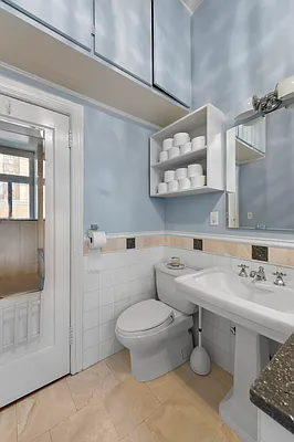 1 West 67th Street, Unit 2M Manhattan, NY 10023 - Photo 8 of 16 a bathroom with a sink toilet and mirror