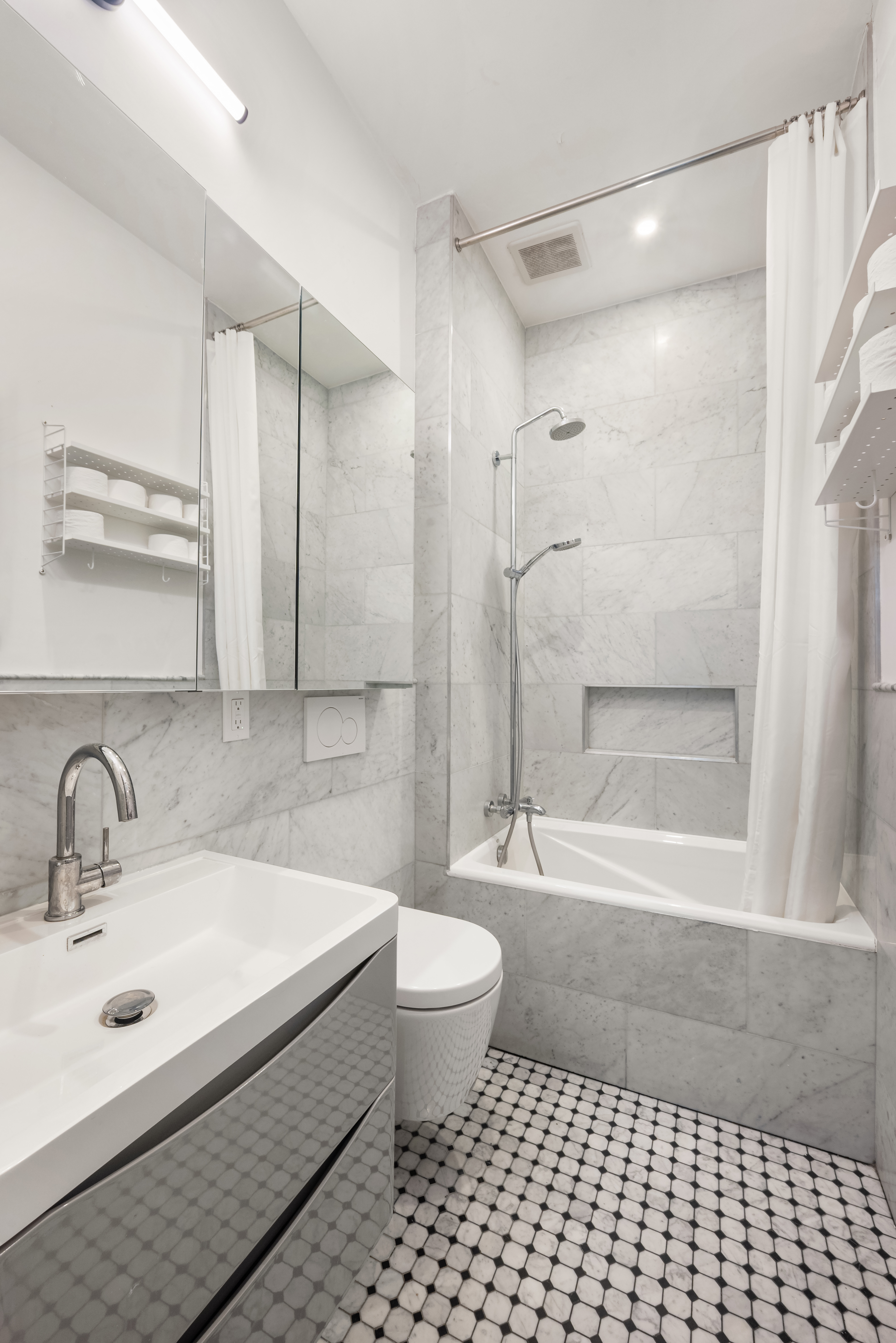 151 East 29th Street, Unit 1 Manhattan, NY 10016 - Photo 7 of 14 a bathroom with a sink a toilet and shower