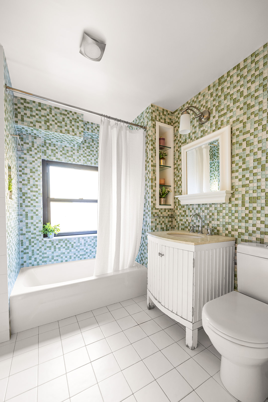 208 East Broadway, Unit J405/J406 Manhattan, NY 10002 - Photo 11 of 21 a bathroom with a granite countertop sink toilet and mirror