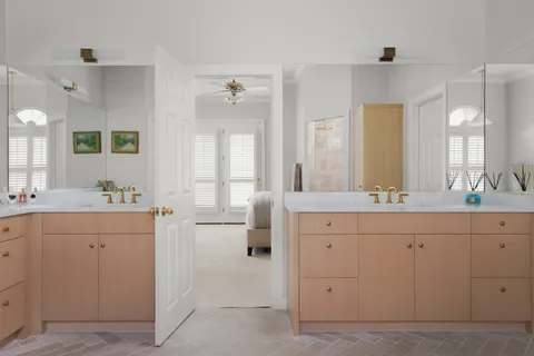 a spacious bathroom with a double vanity sink mirror and double